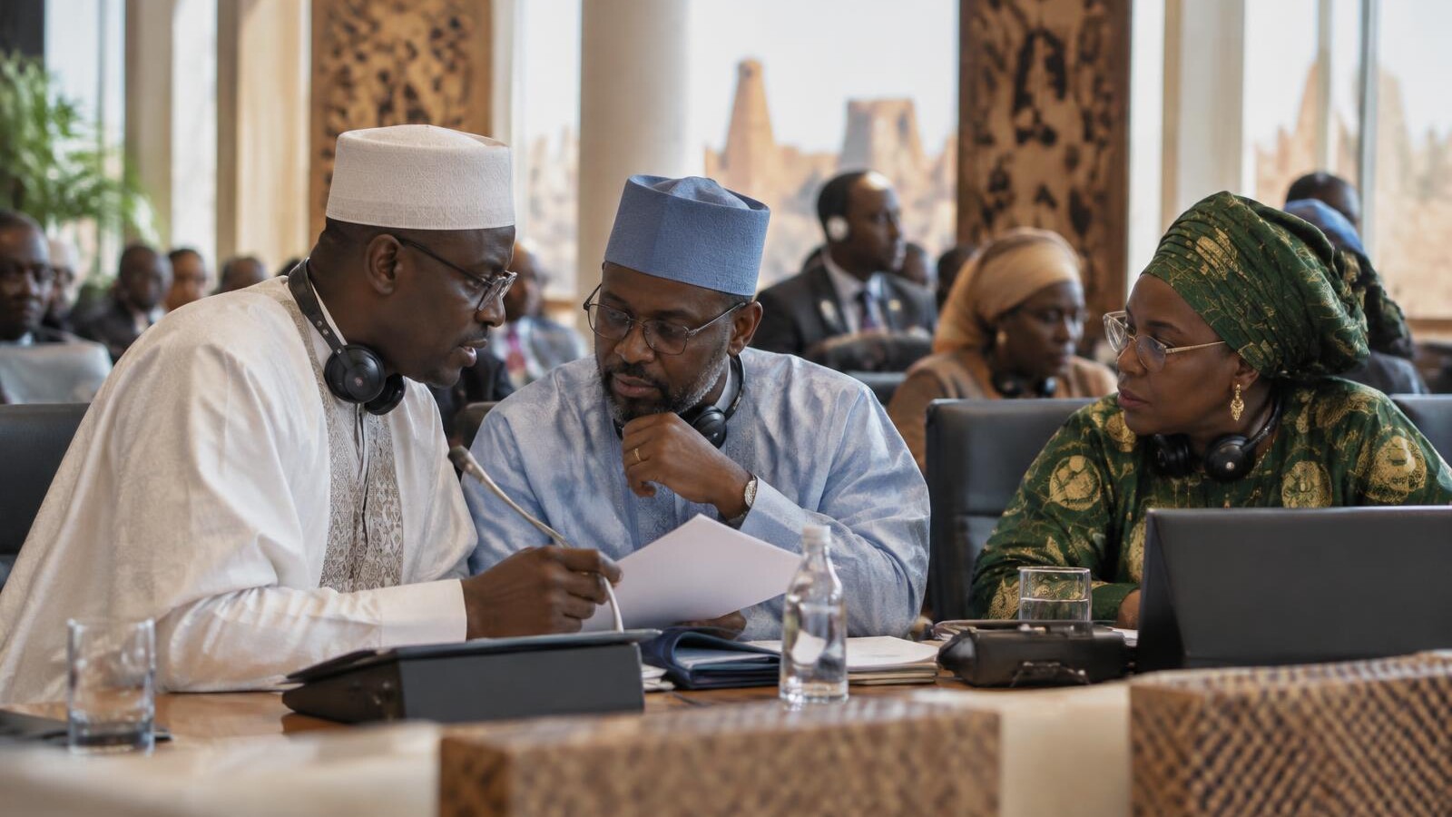 West African delegates in formal discussion at an international diplomatic conference.